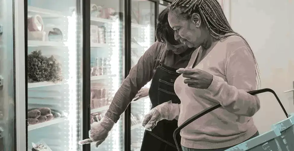 people looking at food in merchandiser refrigerator